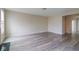 Bright living room with gray wood-look floors, neutral walls, and natural light at 5786 Blue Sky Dr, Whitestown, IN 46075