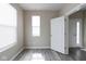 Neutral room featuring gray wood-look flooring, white trim, and natural light at 5786 Blue Sky Dr, Whitestown, IN 46075