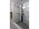 This bathroom has a new glass shower, tile surround, and pebble floor at 5846 Edgewood Trace Blvd, Indianapolis, IN 46239