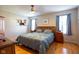 Bedroom featuring wood floors, two windows, a ceiling fan, and nightstands at 5846 Edgewood Trace Blvd, Indianapolis, IN 46239
