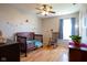 Charming bedroom features wood floors, a ceiling fan, and a cozy rocking chair at 5846 Edgewood Trace Blvd, Indianapolis, IN 46239