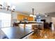 Dining and kitchen area featuring wood floors, neutral walls, stainless steel appliances, and wood cabinets at 5846 Edgewood Trace Blvd, Indianapolis, IN 46239