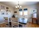 Dining room features a table set with four chairs, a chandelier, and decor on the wall at 5846 Edgewood Trace Blvd, Indianapolis, IN 46239