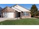 Attractive home features a manicured lawn, brick accents, and updated siding, offering great curb appeal at 5846 Edgewood Trace Blvd, Indianapolis, IN 46239