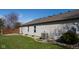 Home's exterior view showcasing well-kept siding, manicured lawn, and modern HVAC system at 5846 Edgewood Trace Blvd, Indianapolis, IN 46239