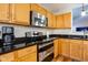 A well-equipped kitchen with stainless steel appliances, granite countertops, and wooden cabinets at 5846 Edgewood Trace Blvd, Indianapolis, IN 46239