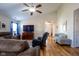 Bright living room with hardwood floors, a ceiling fan, and comfortable seating arrangements at 5846 Edgewood Trace Blvd, Indianapolis, IN 46239