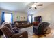Spacious living room features hardwood floors, plush seating, and large windows for natural light at 5846 Edgewood Trace Blvd, Indianapolis, IN 46239