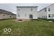 Spacious backyard with a well-maintained lawn, patio, and fire pit at 639 Rocky Meadow Dr, Greenwood, IN 46143
