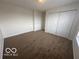 This bedroom features neutral paint, carpet, and a double-door closet at 639 Rocky Meadow Dr, Greenwood, IN 46143