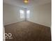 This bedroom features neutral walls, carpet, and a window at 639 Rocky Meadow Dr, Greenwood, IN 46143