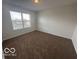 This bedroom features neutral walls, carpet, and a window at 639 Rocky Meadow Dr, Greenwood, IN 46143