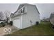 Side view of a two-story home with gray siding and a well-kept lawn at 639 Rocky Meadow Dr, Greenwood, IN 46143