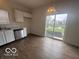 Bright kitchen featuring white cabinetry, stainless steel sink, and a view of the outdoors through the sliding glass door at 639 Rocky Meadow Dr, Greenwood, IN 46143