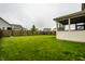 Wide backyard with a well-maintained lawn, wood fence, and screened-in porch perfect for outdoor relaxation at 647 Albermarle Dr, Pittsboro, IN 46167