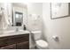 Cozy powder room featuring white vanity and toilet at 647 Albermarle Dr, Pittsboro, IN 46167