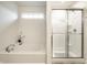Modern bathroom showcasing a soaking tub and separate glass-enclosed shower for a spa-like experience at 647 Albermarle Dr, Pittsboro, IN 46167