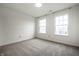 Neutral bedroom features plush carpeting and large windows to provide natural light at 647 Albermarle Dr, Pittsboro, IN 46167