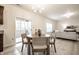 Bright dining area with modern chandelier, table and chairs adjacent to the living room and sliding glass doors at 647 Albermarle Dr, Pittsboro, IN 46167