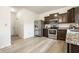 Bright kitchen with stainless steel appliances and wood-look flooring at 647 Albermarle Dr, Pittsboro, IN 46167