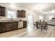 Spacious kitchen with stainless steel appliances, dark wood cabinets and adjacent dining area at 647 Albermarle Dr, Pittsboro, IN 46167
