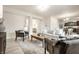 Spacious living room with a view into the kitchen, featuring comfortable seating, hardwood floors, and natural light at 647 Albermarle Dr, Pittsboro, IN 46167