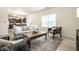 Cozy living room with plush sofa and chairs, complemented by hardwood floors, a decorative rug, and natural light at 647 Albermarle Dr, Pittsboro, IN 46167