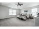Large main bedroom with tray ceiling, ceiling fan, and ample natural light at 647 Albermarle Dr, Pittsboro, IN 46167
