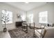 Bright office with lots of natural light, decorative rug, modern furniture and stylish decor for a productive workspace at 647 Albermarle Dr, Pittsboro, IN 46167