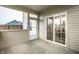 Screened patio with sliding door access and views of the well-maintained backyard at 647 Albermarle Dr, Pittsboro, IN 46167