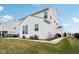 Spacious backyard featuring well-maintained siding, mature landscaping, and a concrete path leading to outdoor spaces at 6630 Overlander Ln, Whitestown, IN 46075