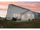 A well-maintained backyard and patio enhance this home's exterior, perfect for enjoying sunset views at 6630 Overlander Ln, Whitestown, IN 46075
