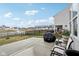 Backyard with a patio, seating area, grill, and a view of a nearby pond and neighborhood at 6630 Overlander Ln, Whitestown, IN 46075