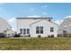 Well-maintained home exterior features a spacious backyard with a patio and manicured lawn for outdoor enjoyment at 6630 Overlander Ln, Whitestown, IN 46075