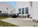 Backyard patio with chairs, grill and a manicured lawn at 6630 Overlander Ln, Whitestown, IN 46075