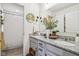 Bathroom boasts granite countertops, double sinks, and a decorative mirror and floral arrangement at 6630 Overlander Ln, Whitestown, IN 46075