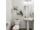 A small bathroom with a pedestal sink, a toilet, and decor shelves at 6630 Overlander Ln, Whitestown, IN 46075