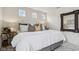 Bright bedroom featuring a plush bed, stylish pillows, and a decorative mirror on the wall at 6630 Overlander Ln, Whitestown, IN 46075