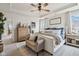 Bright bedroom features tray ceilings, neutral walls, and plush bed with stylish decor and a ceiling fan at 6630 Overlander Ln, Whitestown, IN 46075