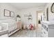 Bright Bedroom features a crib, soft rug, a changing table, and decor at 6630 Overlander Ln, Whitestown, IN 46075