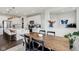 Bright open-concept dining area next to kitchen with wood table and white cabinets at 6630 Overlander Ln, Whitestown, IN 46075