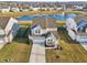Beautiful home with manicured lawn and landscaping, charming front porch, and attached two-car garage at 6630 Overlander Ln, Whitestown, IN 46075