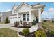 Inviting exterior featuring a front porch seating area and landscaped front yard at 6630 Overlander Ln, Whitestown, IN 46075