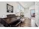 Inviting entry featuring a piano, wood floors, and an open view to other living spaces at 6630 Overlander Ln, Whitestown, IN 46075