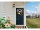 Close-up of the front door adorned with a decorative wreath and a charming welcome mat at 6630 Overlander Ln, Whitestown, IN 46075