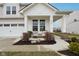 Inviting front porch with comfortable seating and attractive landscaping details at 6630 Overlander Ln, Whitestown, IN 46075