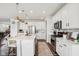 Well-lit kitchen featuring white cabinets, subway tile backsplash, and a center island with barstool seating at 6630 Overlander Ln, Whitestown, IN 46075