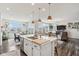 Open concept kitchen provides an island with bar seating with an adjacent living and dining area at 6630 Overlander Ln, Whitestown, IN 46075