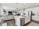 Open concept kitchen and living area boasts a large island, stainless appliances, and seamless flow at 6630 Overlander Ln, Whitestown, IN 46075