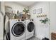 Laundry room with washer, dryer, shelving, and decor for an organized space at 6630 Overlander Ln, Whitestown, IN 46075